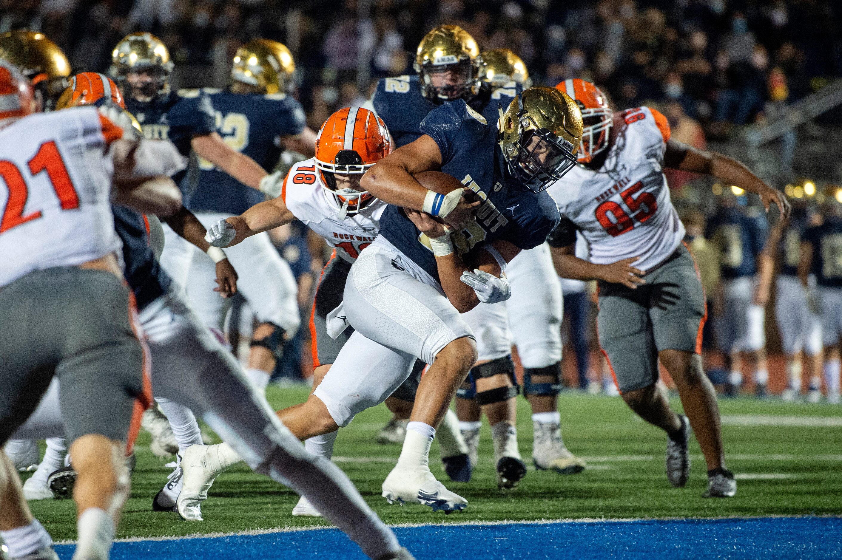 Jesuit junior quarterback Robert Fitzgerald (18) runs in for a touchdown past Rockwall...