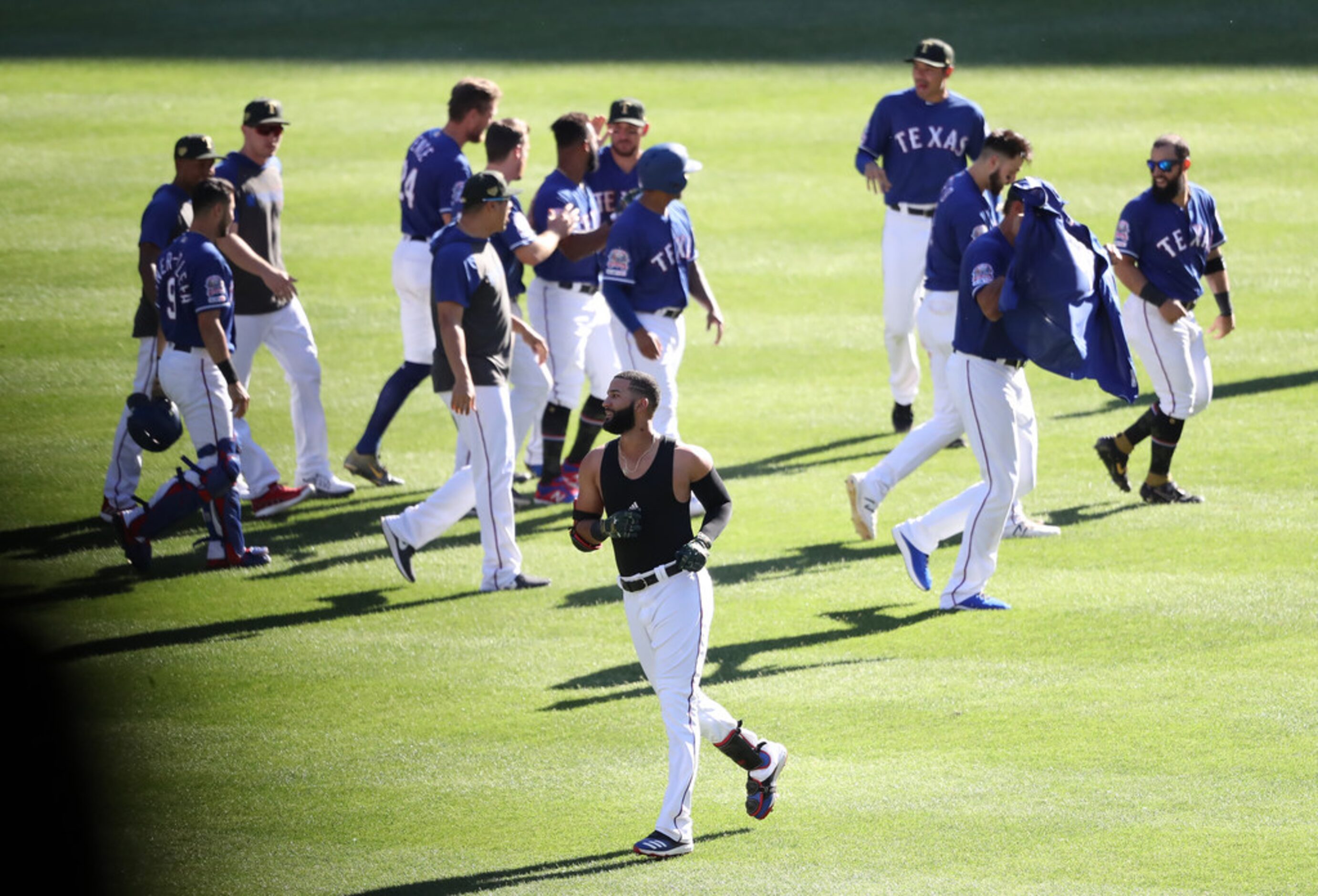 ARLINGTON, TEXAS - MAY 19:  The Texas Rangers celebrate the game winning run scored on a...