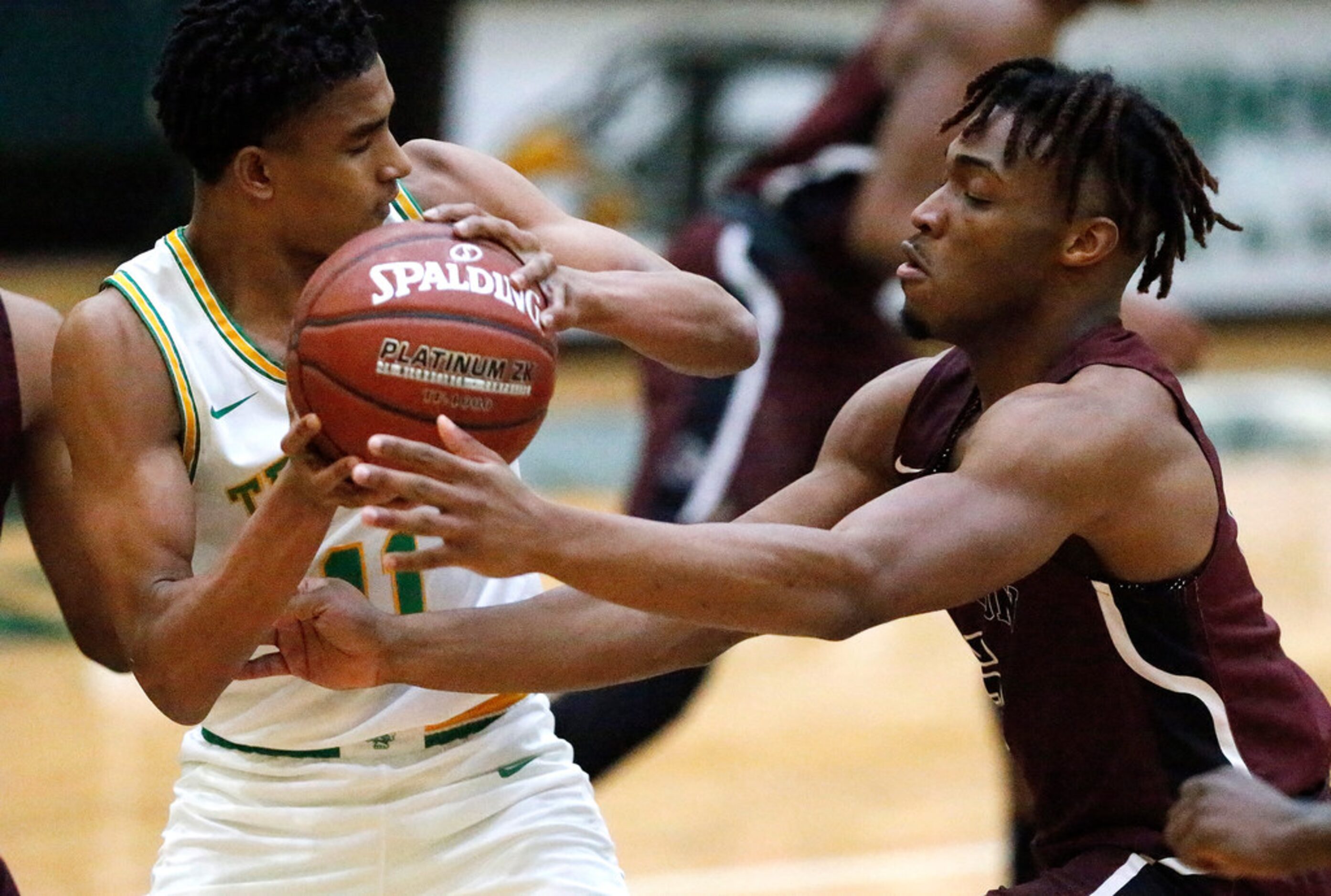 Madison High School Jerome Rogers (11) tries to pass as Jefferson High School guard Kylan...