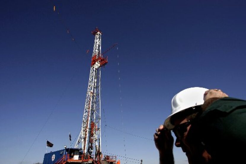 Trevor Rees-Jones, CEO of Chief Oil & Gas, dons a hard hat at a Chief oil rig site in Azle....