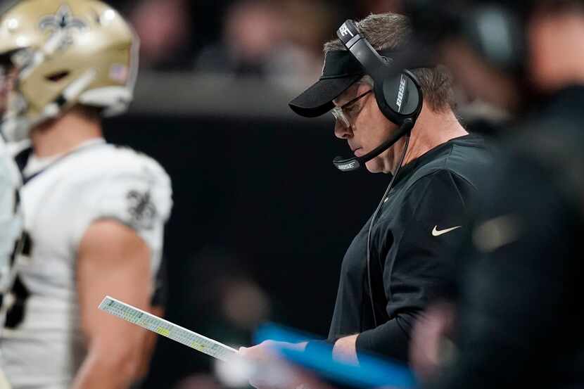 New Orleans Saints head coach Sean Payton looks over plays on the sidelines during the first...