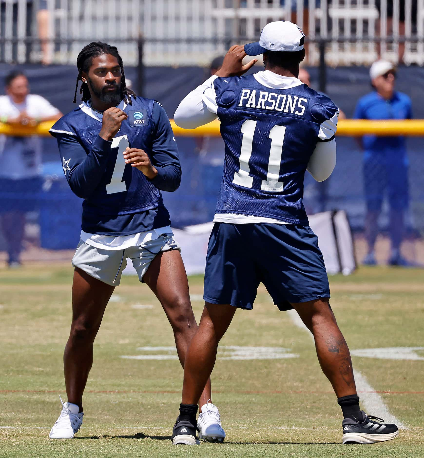 Dallas Cowboys cornerback Trevon Diggs (7) and linebacker Micah Parsons (11) playfully spar...