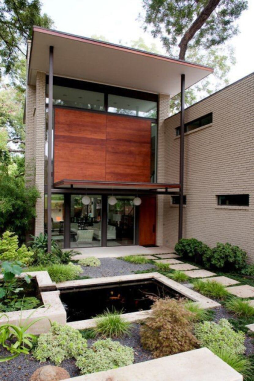 W2 Studio designed a vertical house in Lakewood to nestle among the mature pecan trees. A...