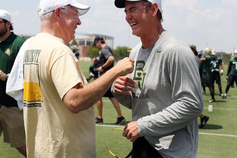 FILE - In this Aug. 5, 2014, file photo,Baylor University President Ken Starr, left, jokes...