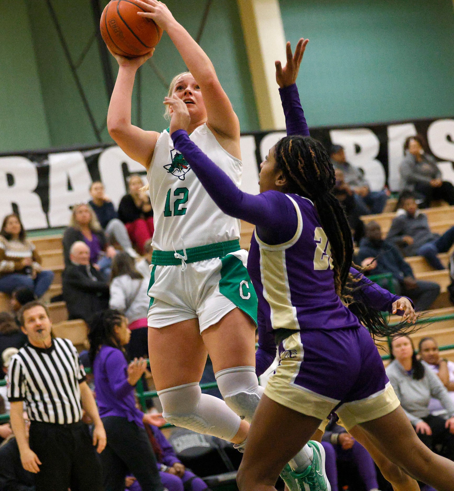 Southlake Carroll's Taryn Barnes (12) shoots over Keller Timber Creek's Selah Armstrachan...