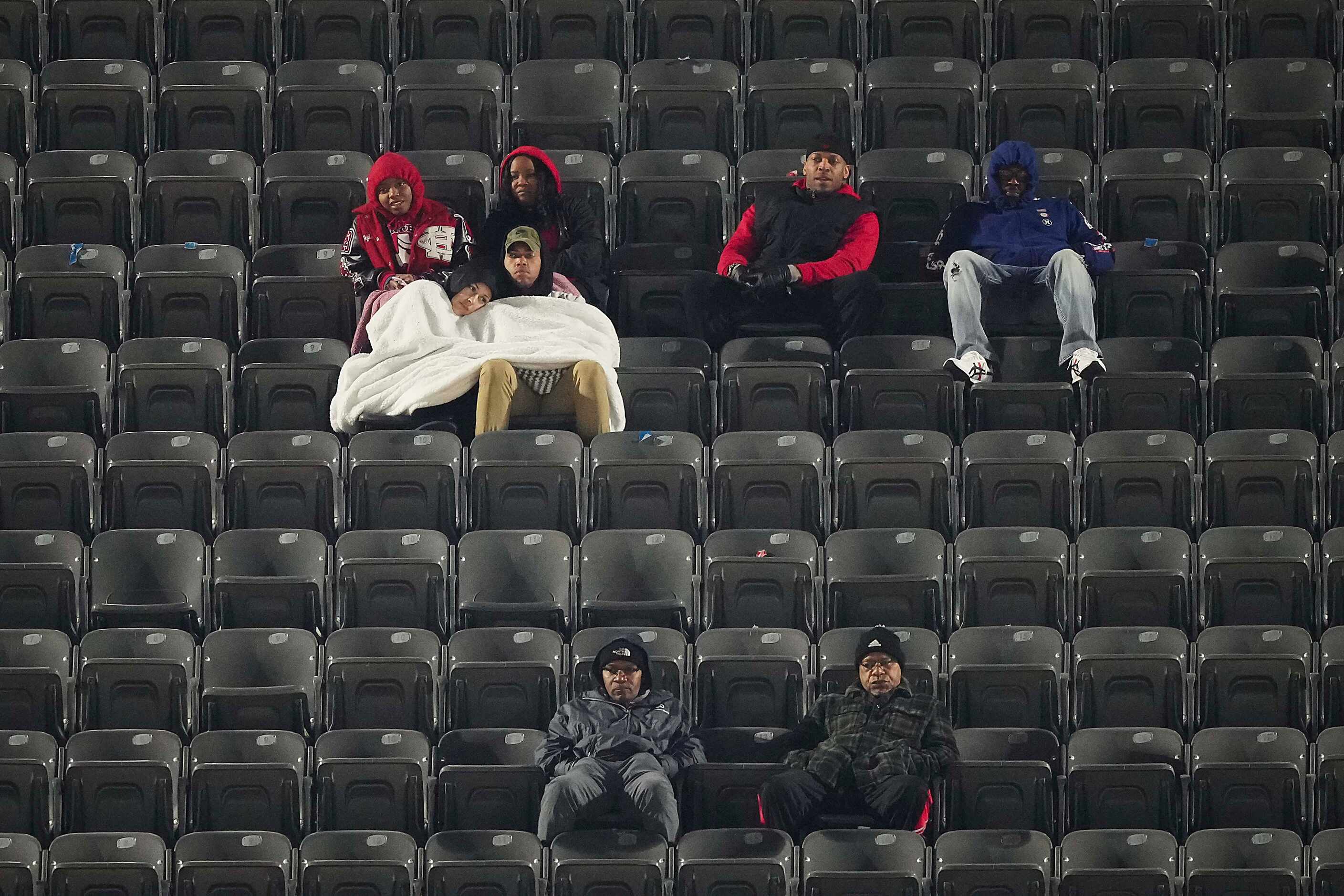 Cedar Hill fans bundle up against the cold as they look on during the second half of a loss...