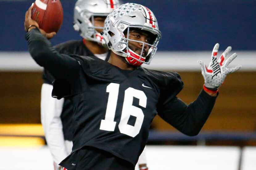 Ohio State's quarterback J.T. Barrett (16)throws a pass during practice against USC for the...