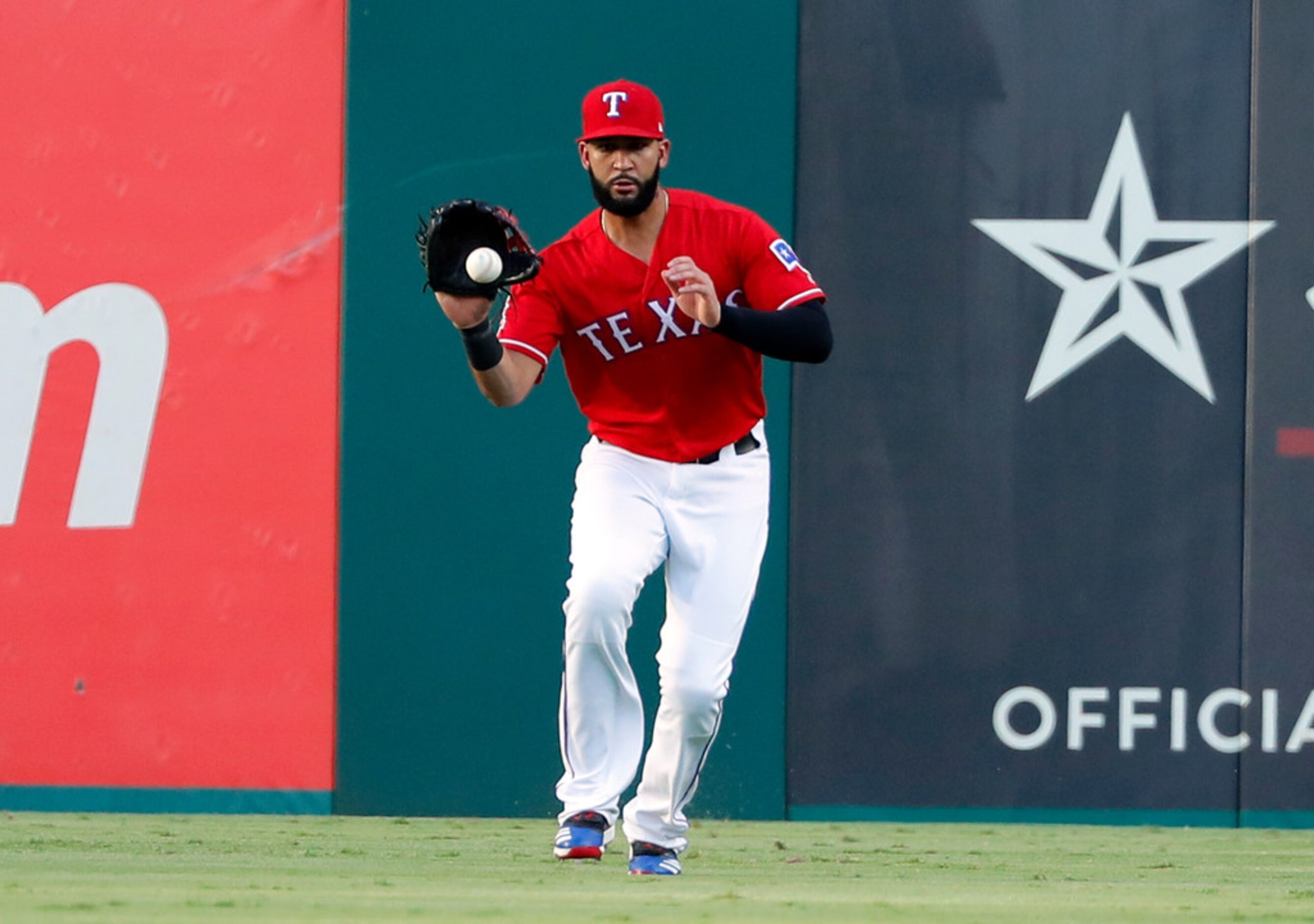 Texas Rangers' Nomar Mazara fields a run-scoring single by Los Angeles Angels' Kole Calhoun...