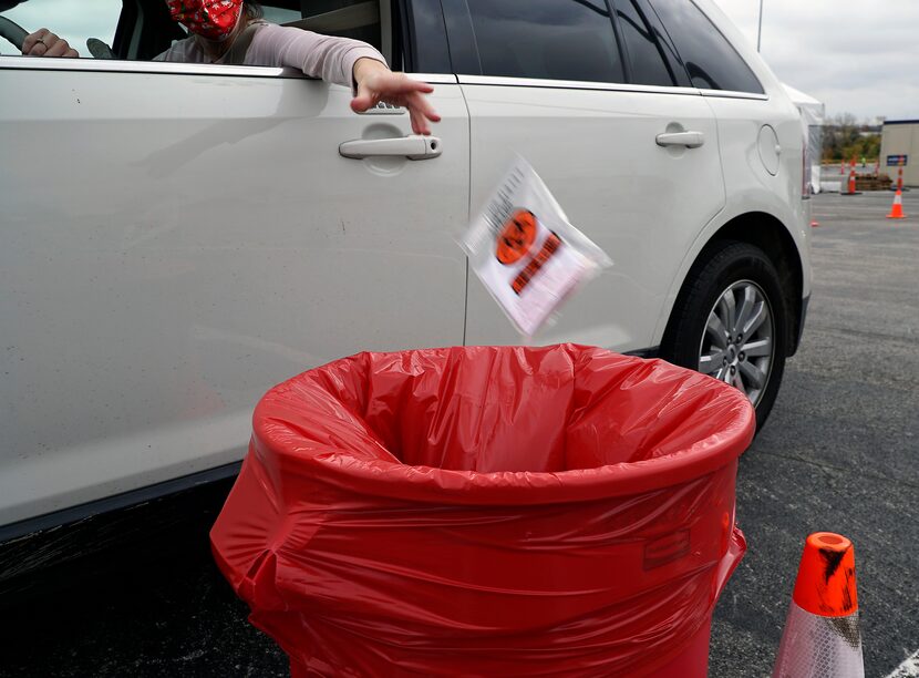 Self-administered mouth swabs being dropped off at a Curative site in the parking lot of...