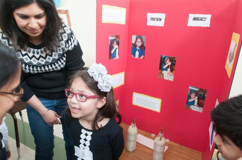 Maya Patel,5, describes her science project on friction during the Children's Garden...