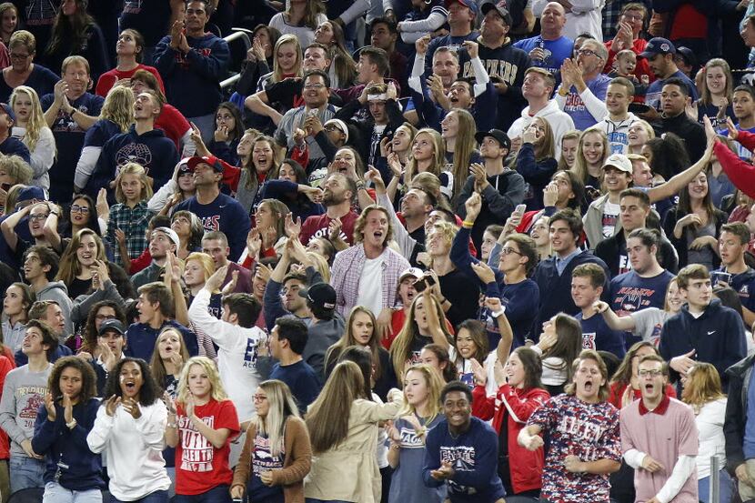 Allen High School fans react to a kickoff returned for a touchdown during the second quarter...