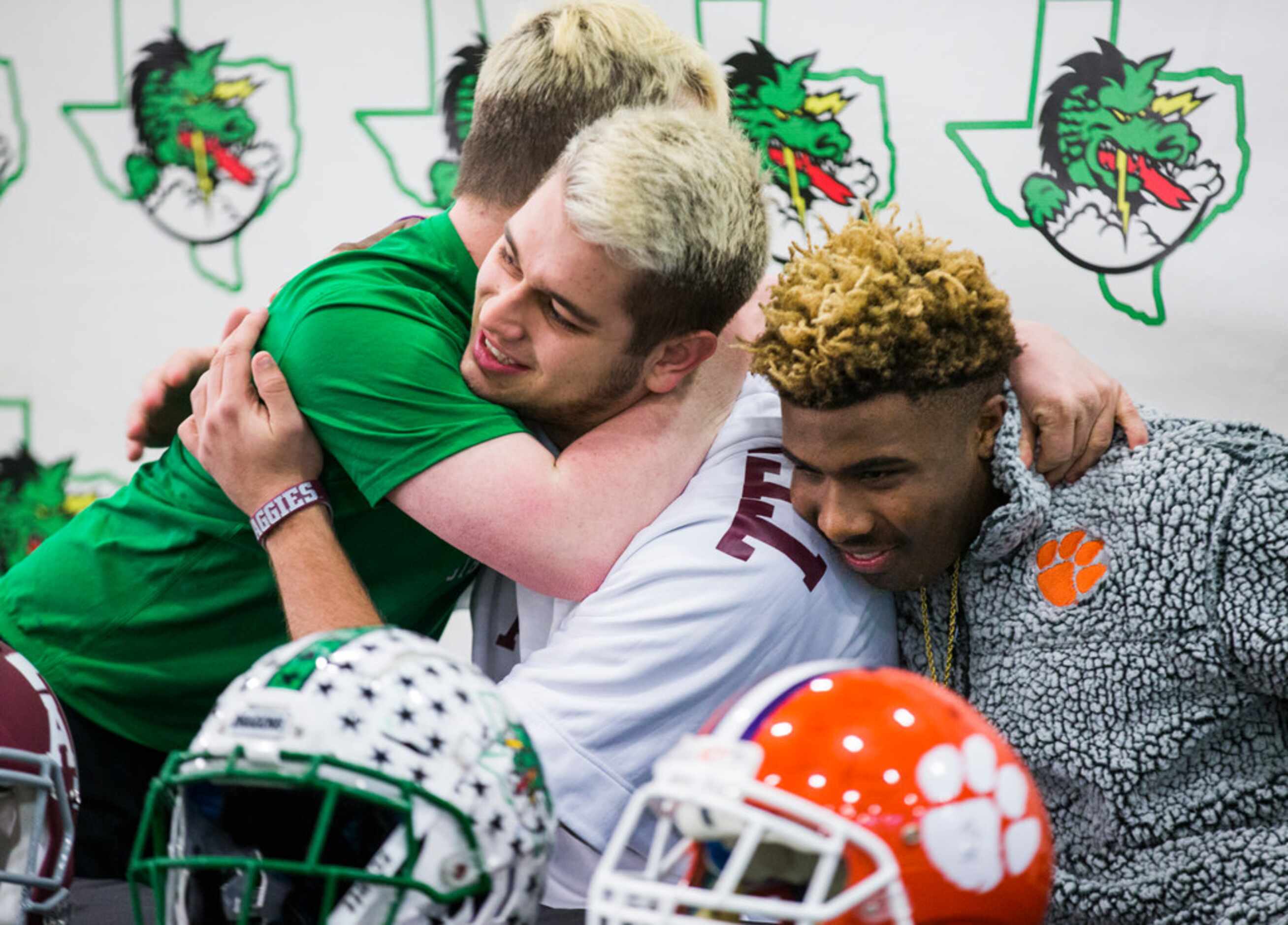 Southlake Carroll football players Blake Smith (center) and RJ Mickens (right) get a hug...