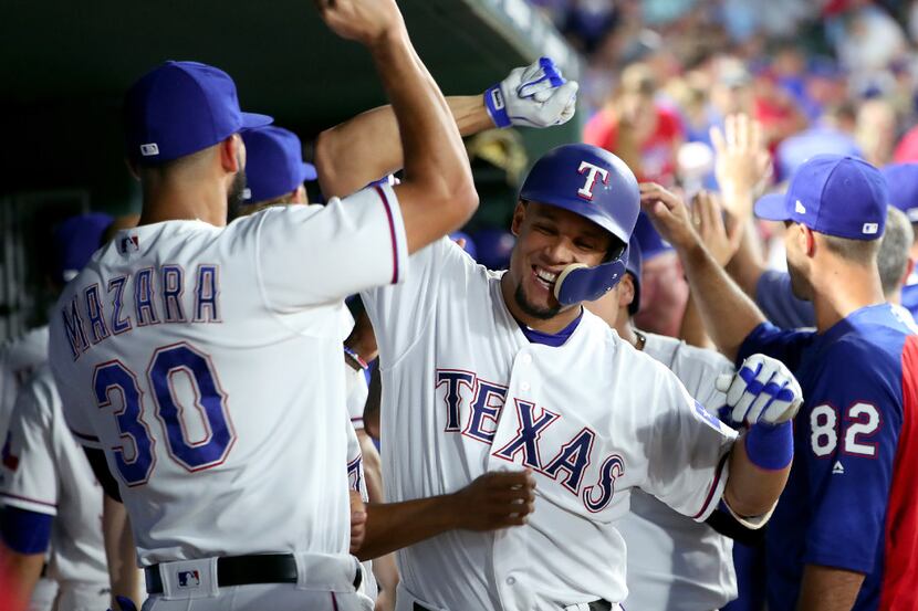 ARLINGTON, TX - JUNE 16:  Carlos Gomez #14 of the Texas Rangers celebrates with Nomar Mazara...