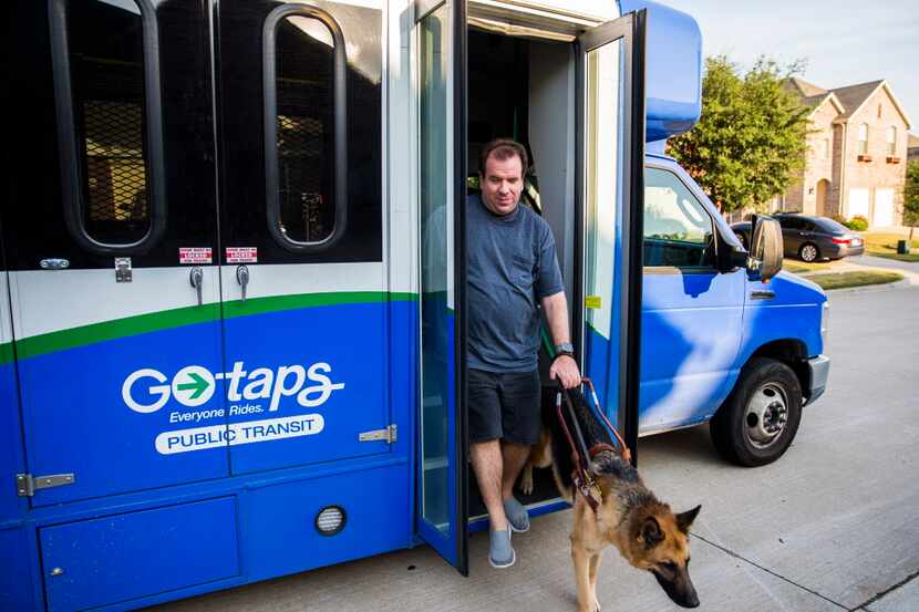 
Justin Mann and his guide dog Garvey arrive home after a TAPS Public Transit bus ride on...