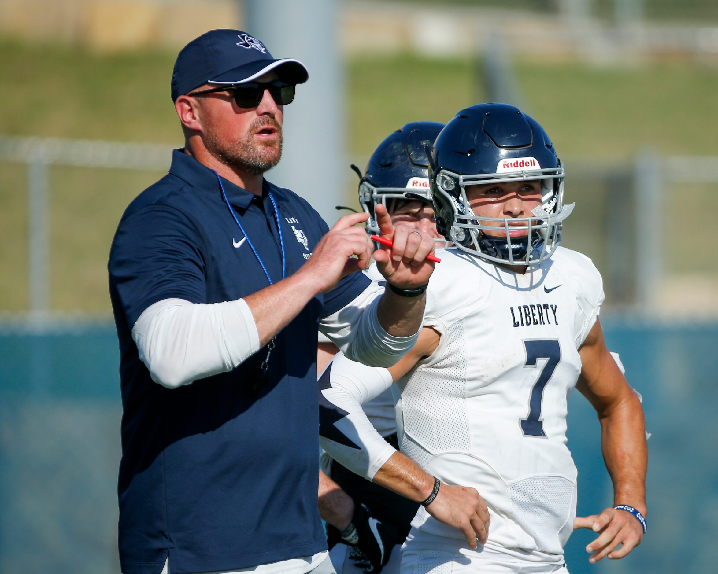 Argyle Liberty Christian head coach Jason Witten signals to players during a football...