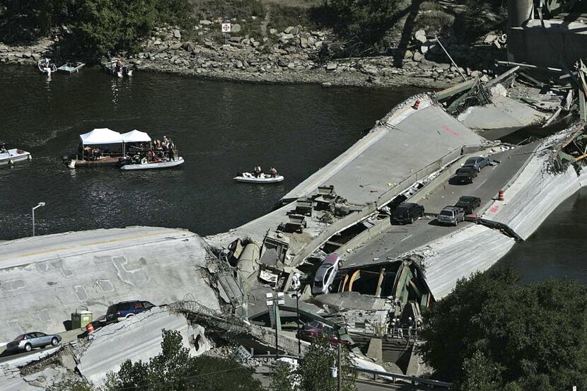 FILE photo shows divers during recovery efforts following the 35W bridge collapsed in...