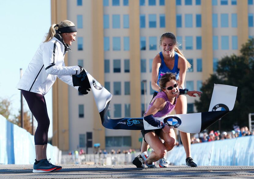 Shalane Flanagan, four-time Olympian, left, watches as Chandler Self, winner of the full...