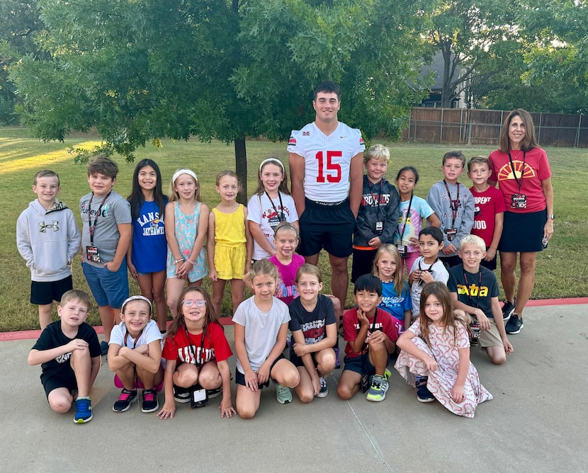 Flower Mound Marcus  Brock Golwas takes a photo with students at Bridlewood Elementary.