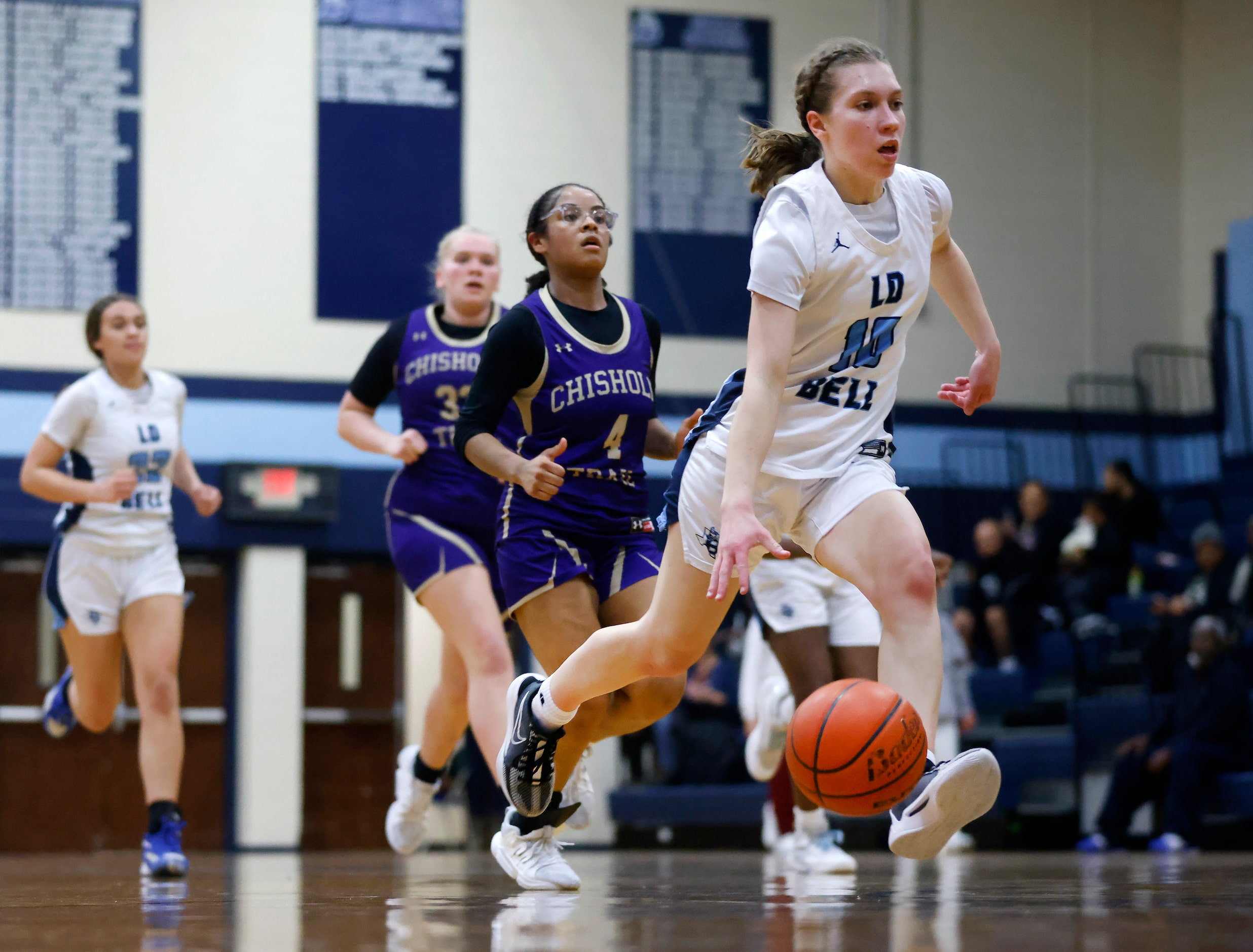 Hurst L.D. Bell’s Katelyn Tietjen drives the ball down court against Saginaw Chisholm Trail...