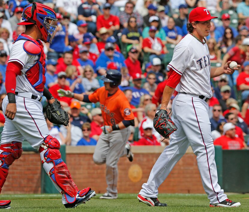 Texas Rangers catcher Robinson Chirinos (61) walks out to talk to starting pitcher Derek...