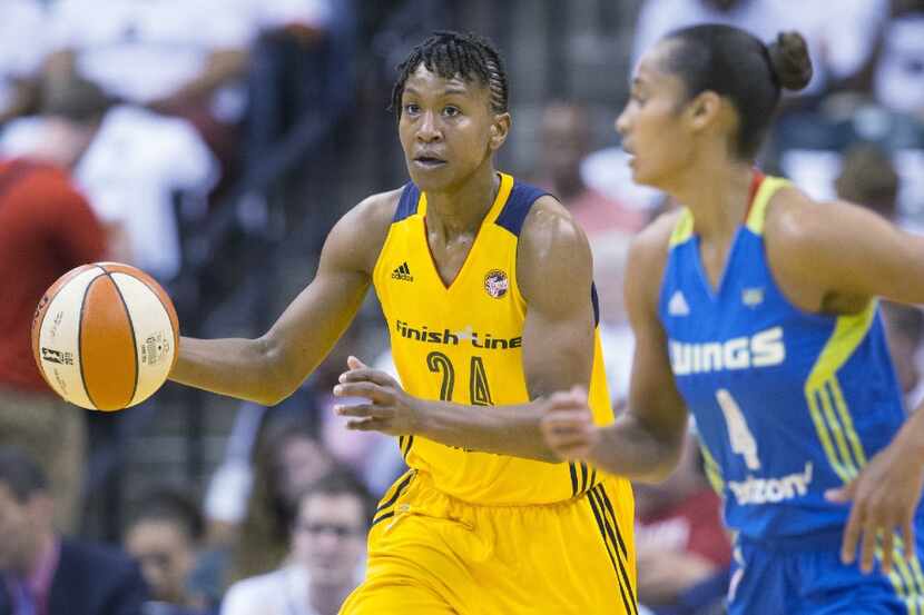 Indiana Fever's Tamika Catchings dribbles the ball during a WNBA basketball game against the...