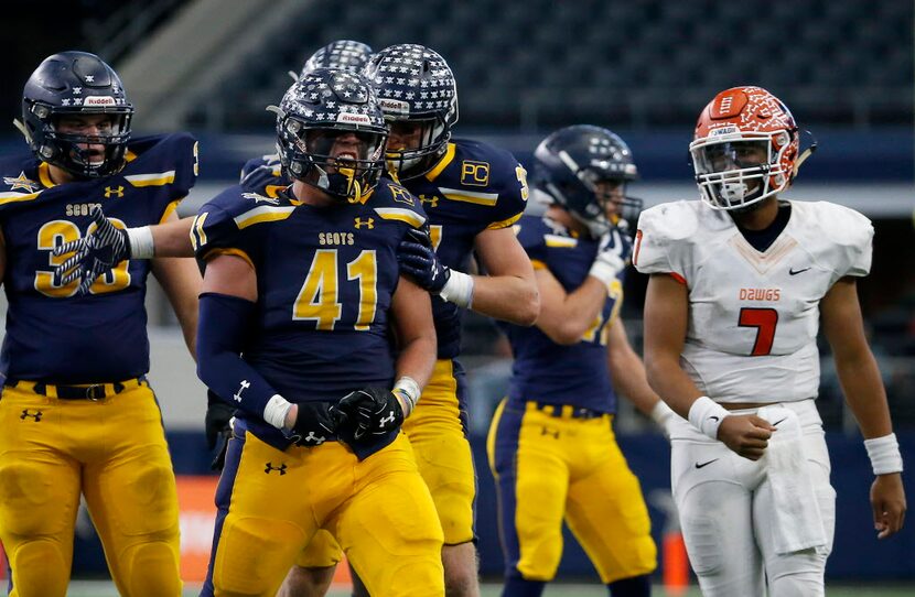 Highland Park's Elliott Newsom (41) celebrates with teammate Marshall Ballard (37) after he...