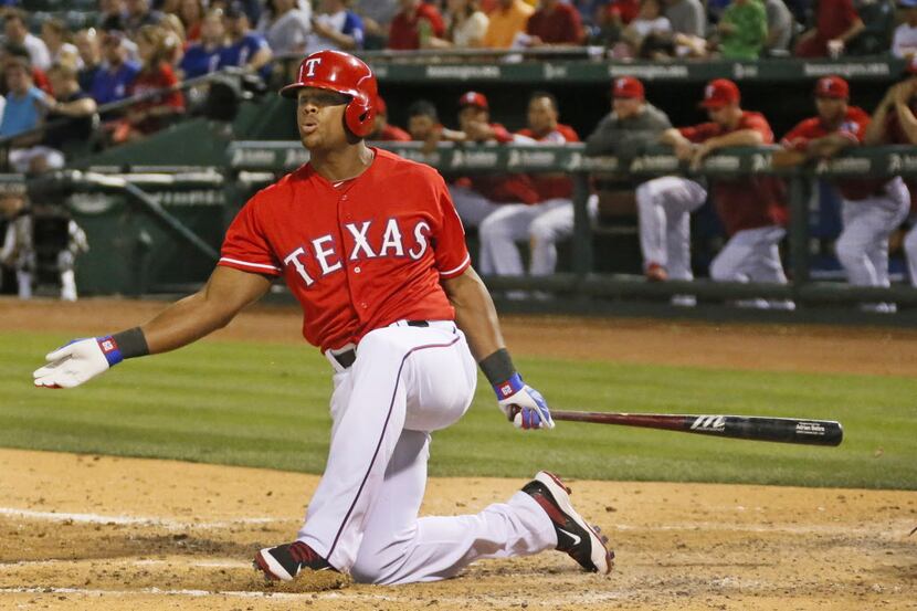 Texas third baseman Adrian Beltre loses his balance on a swing in the seventh, during an at...