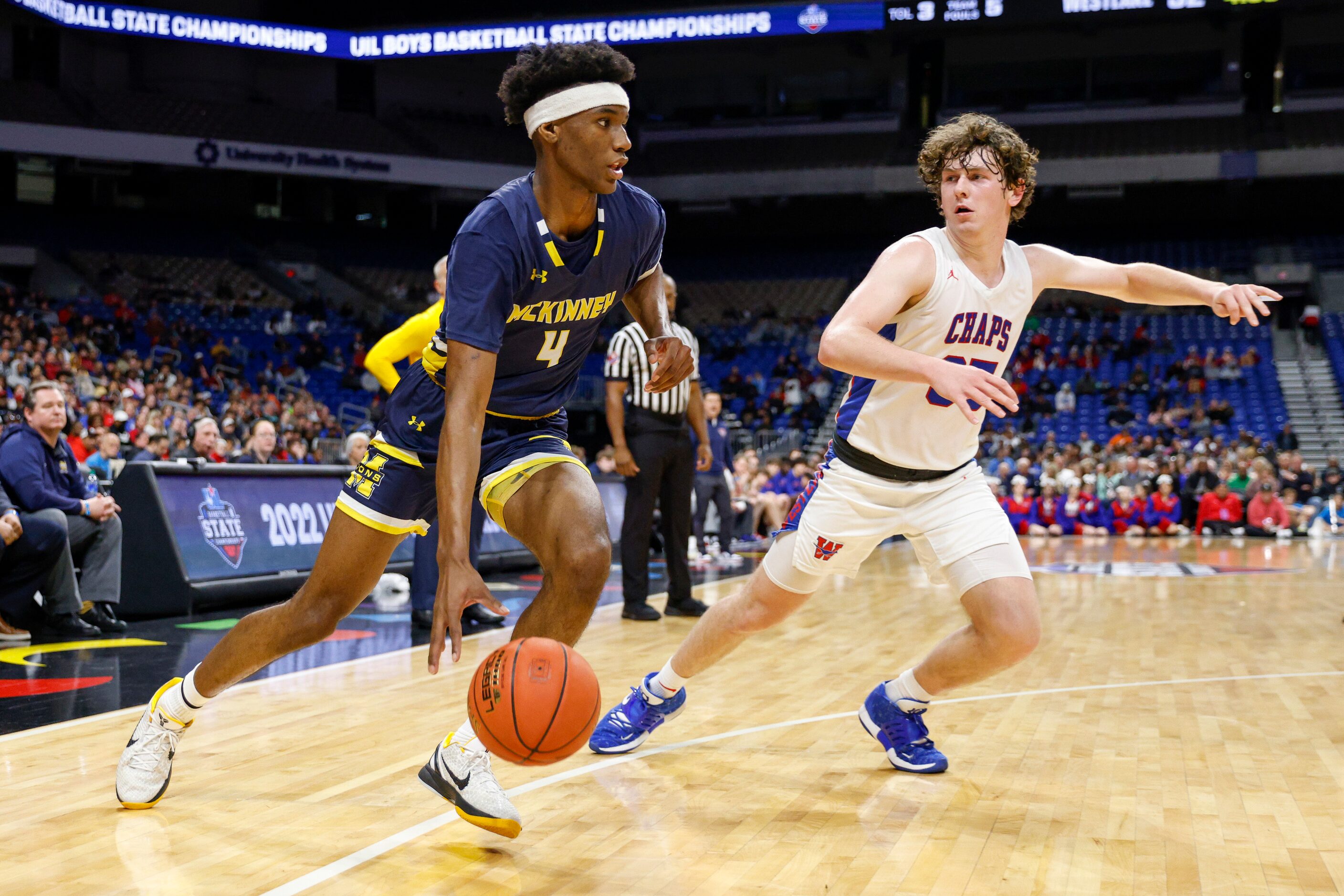 McKinney guard Ja'Kobe Walter (4) dribbles past Austin Westlake guard Conor McManus (35)...