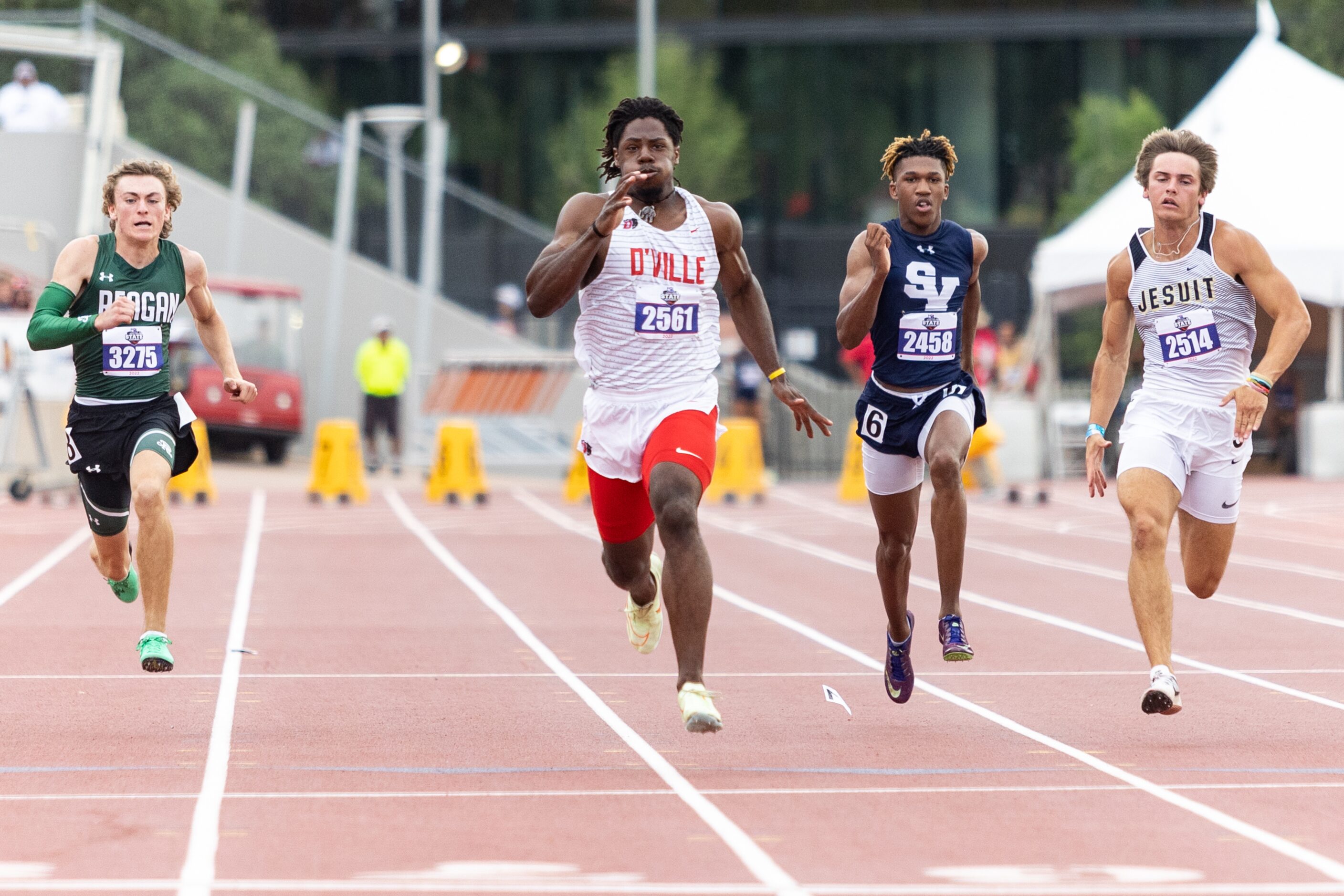 Pierre Goree of Duncanville, center, sprints to the finish line at the UIL Track & Field...