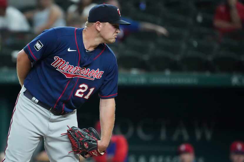 Minnesota Twins relief pitcher Tyler Duffey looks for a sign during the tenth inning against...