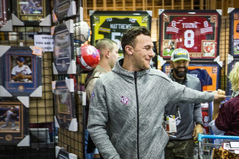 Former Texas A&M and Cleveland Browns quarterback Johnny Manziel waves to fans as he arrives...