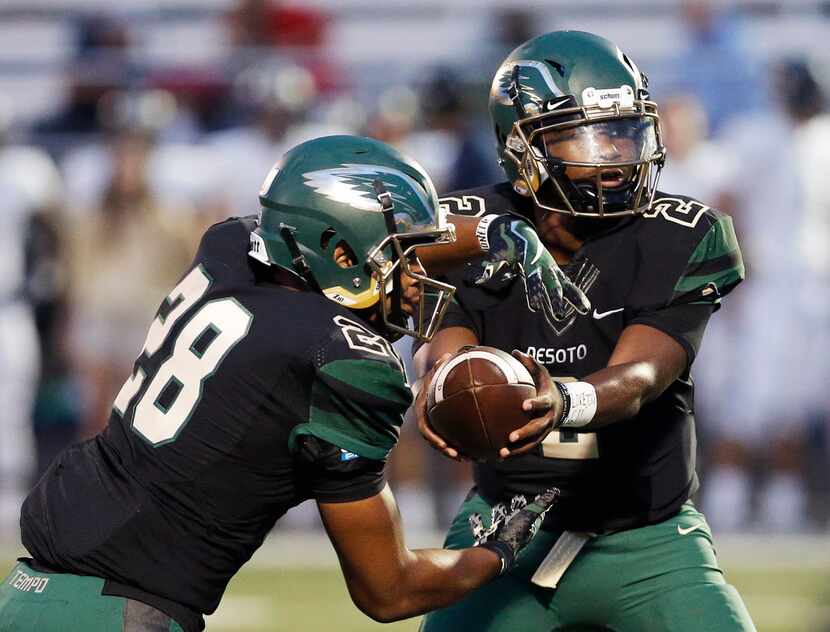 DeSoto quarterback Shun'Darion Ward (2) fakes a handoff to running back Roston White (28)...