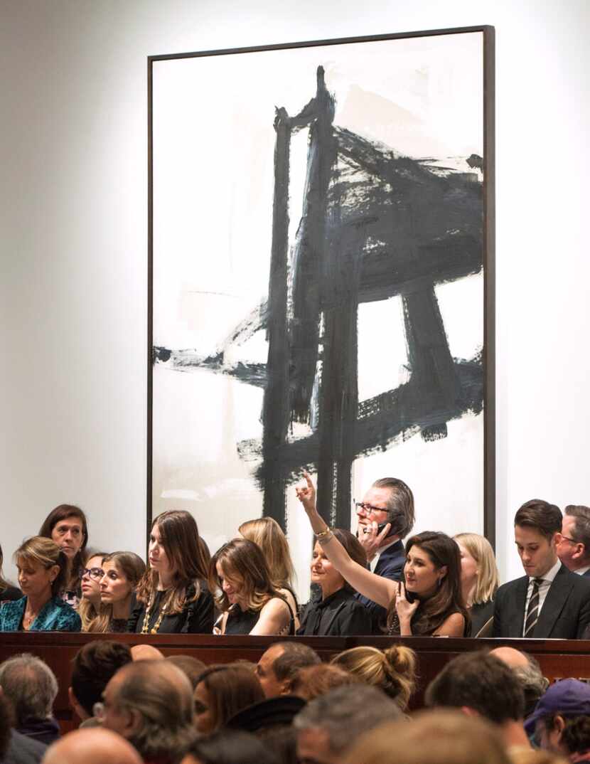 Dallas-based Capera Ryan (lower right, with hand up), Deputy Chairman of Christie's, takes a...
