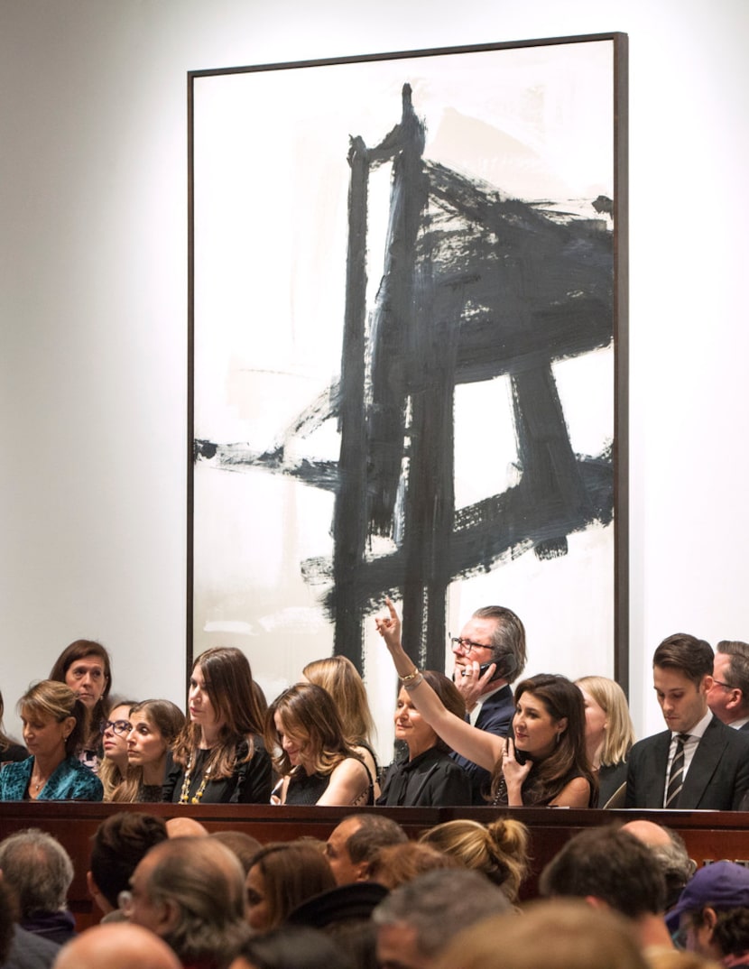 Dallas-based Capera Ryan (lower right, with hand up), Deputy Chairman of Christie's, takes a...