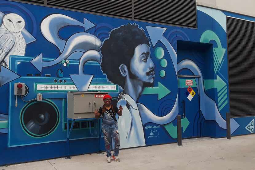 An artist stands in front of his mural in Blues Alley in Dallas' Deep Ellum.