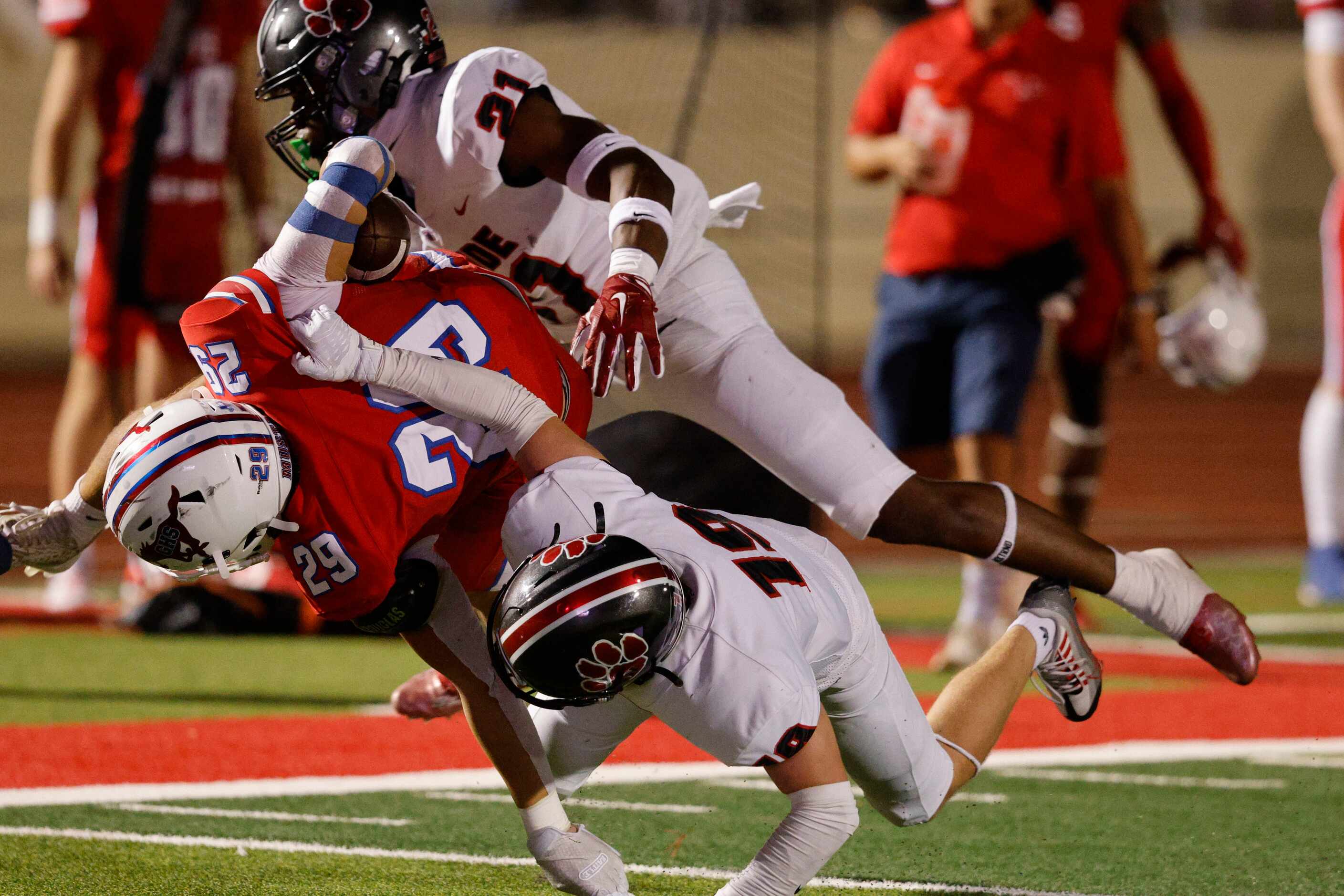 Colleyville Heritage's Bryce Abram (21) and Colleyville Heritage's Alex Burk (19) go to stop...