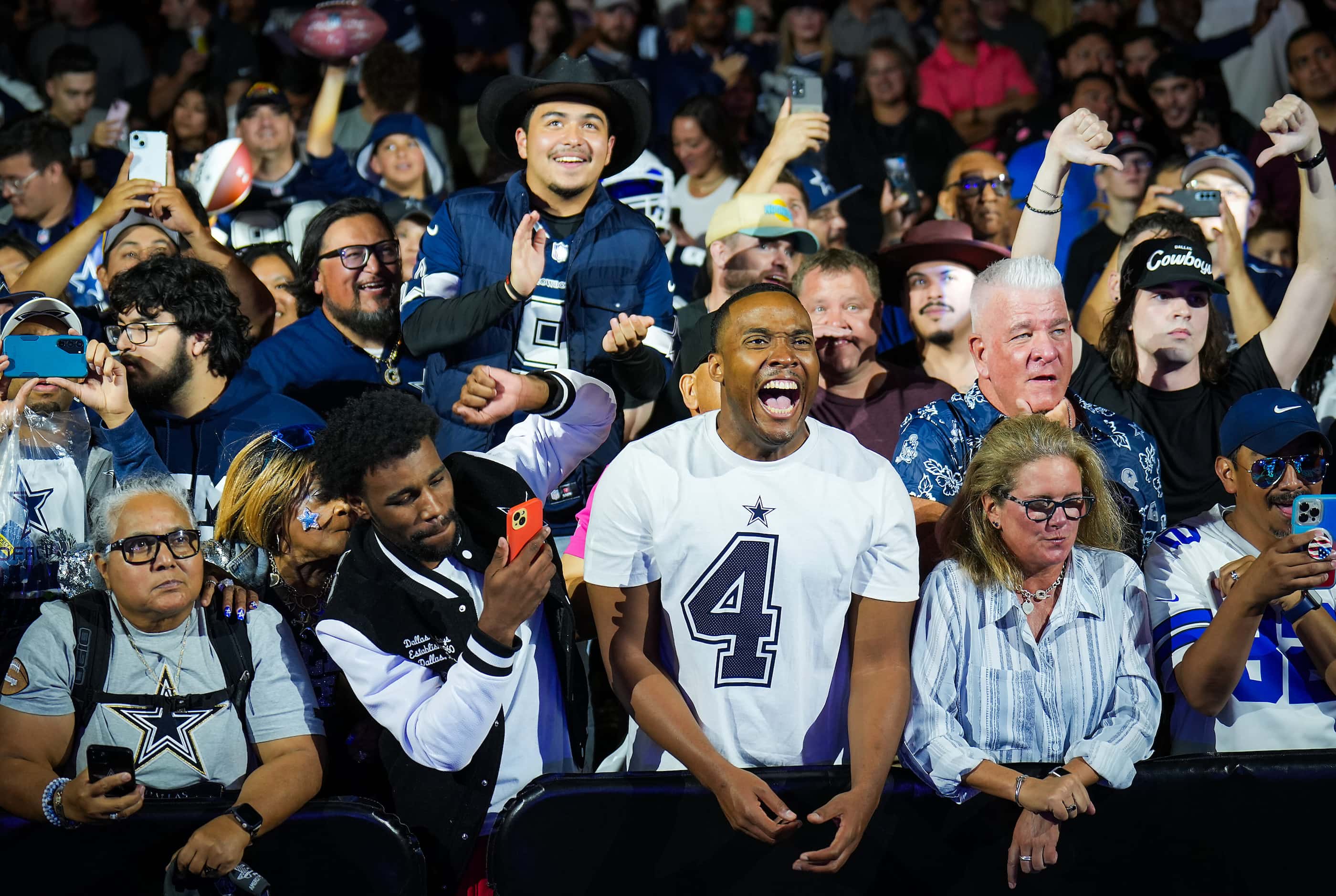 Dallas Cowboys fans react after it was announced that the team traded the 24th pick for the...