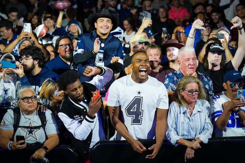 Dallas Cowboys fans react after it was announced that the team traded the 24th pick for the...