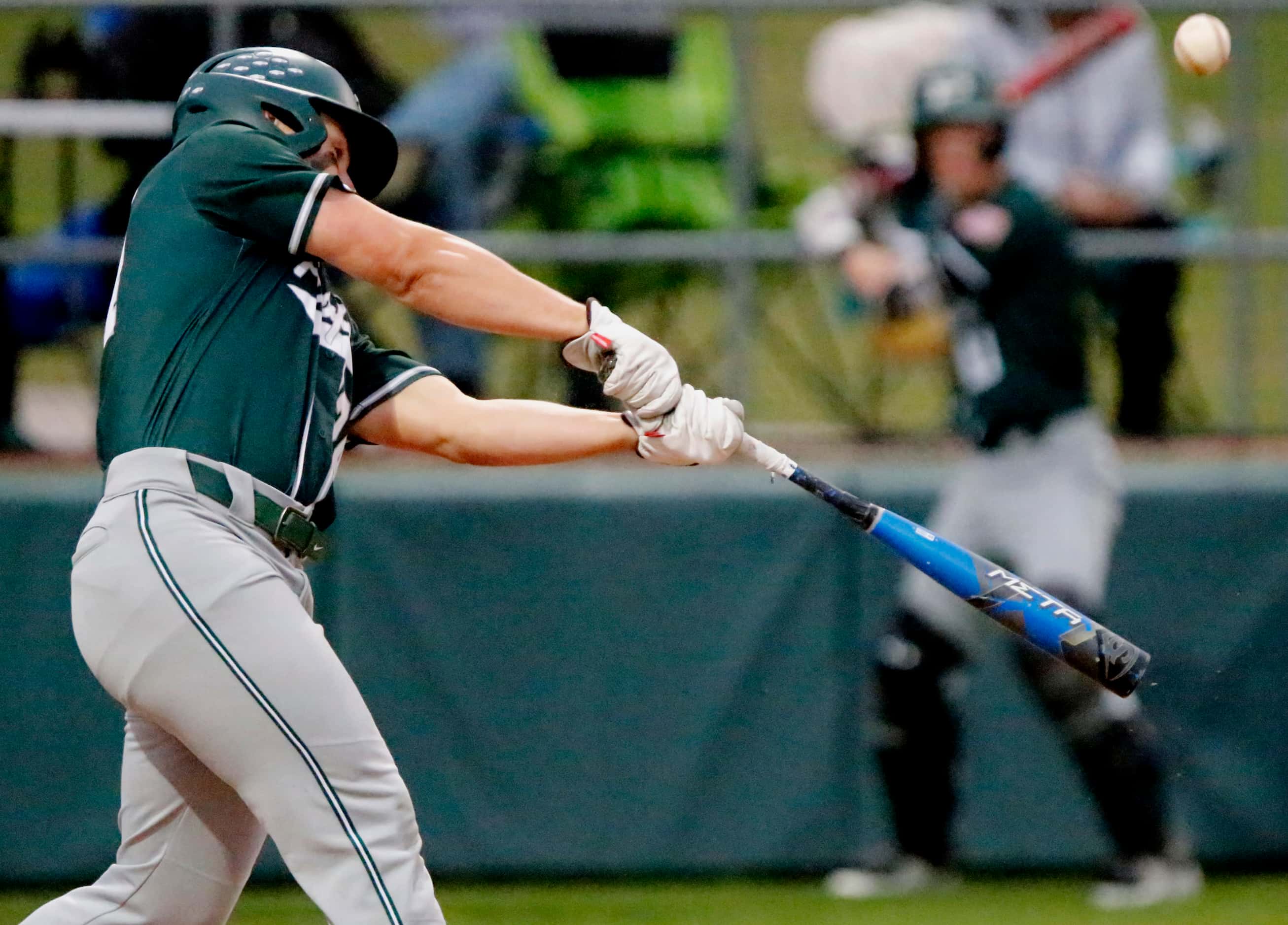 Prosper centerfielder Jacob Devenny (24) makes contact in the second inning as Denton...