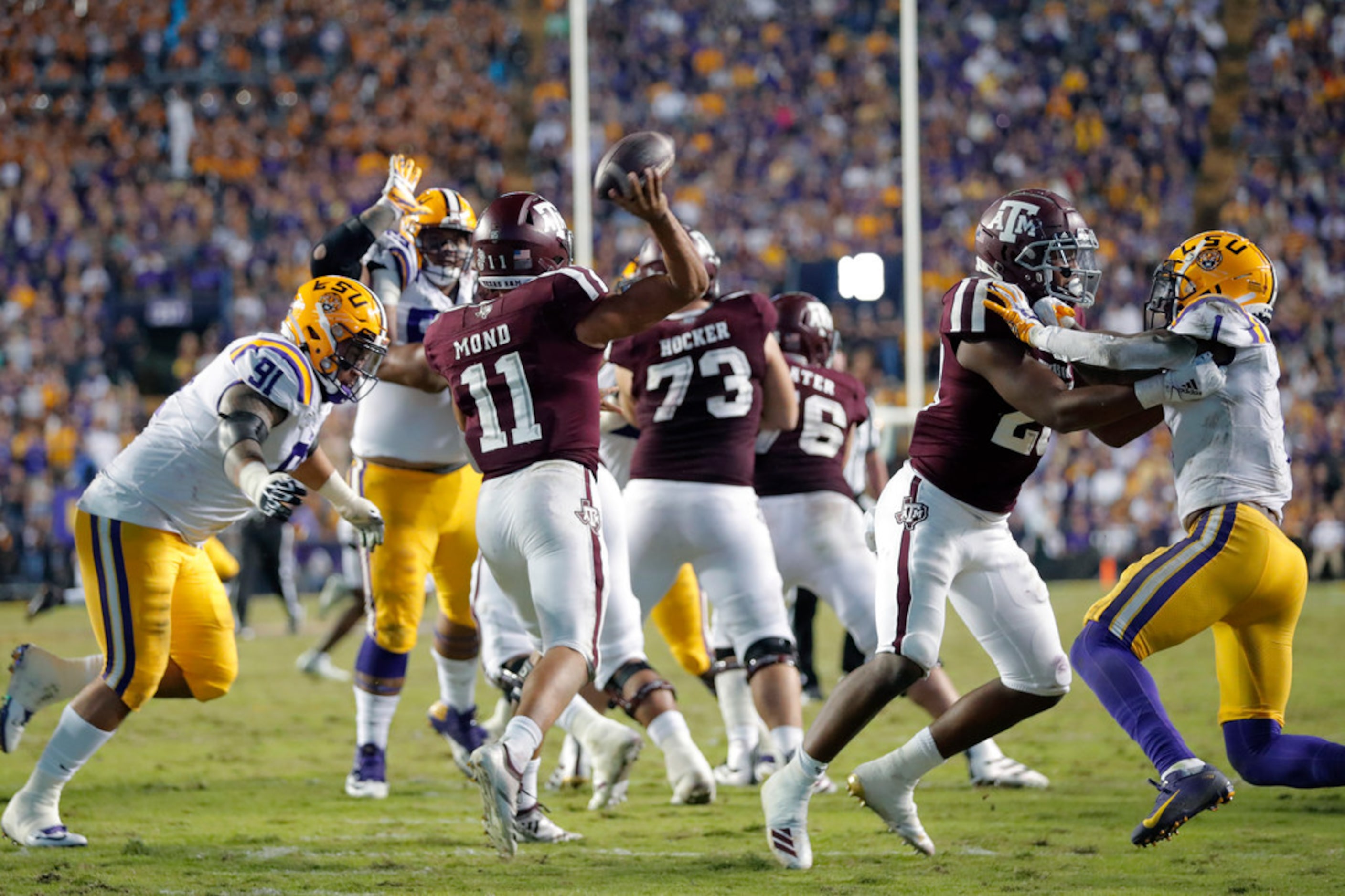 Texas A&M quarterback Kellen Mond (11) passes under pressure from LSU defensive lineman...