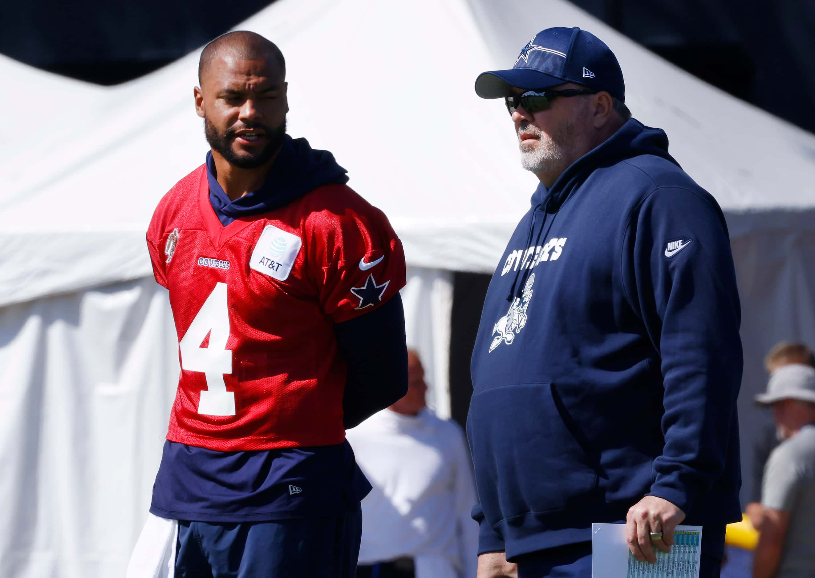 Dallas Cowboys quarterback Dak Prescott (4) visits with head coach Mike McCarthy between...