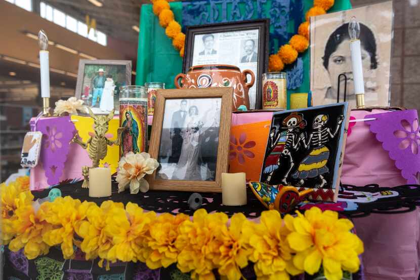 Photographs of relatives decorate the Pleasant Grove Library altar for Dia de los Muertos in...