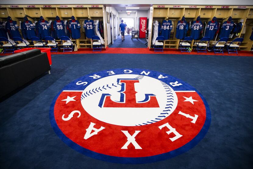 FILE - The team logo fills the center of the clubhouse in the Rangers' spring training...