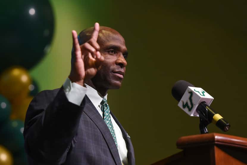 South Florida's new NCAA college football head coach Charlie Strong gestures during a press...