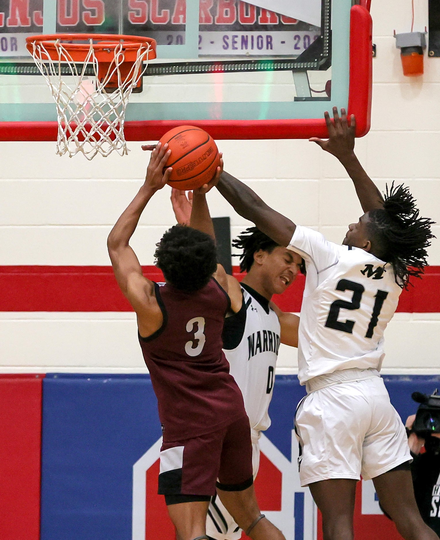 Arlington Martin guard Josiah Charles (21) blocks a shot against Lewisville guard Tre'lin...