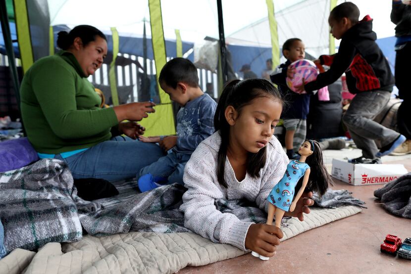 Irma Rivera, 31, left, of Honduras, shown with son Jesus Rodriguez, 4, center, and daughter...