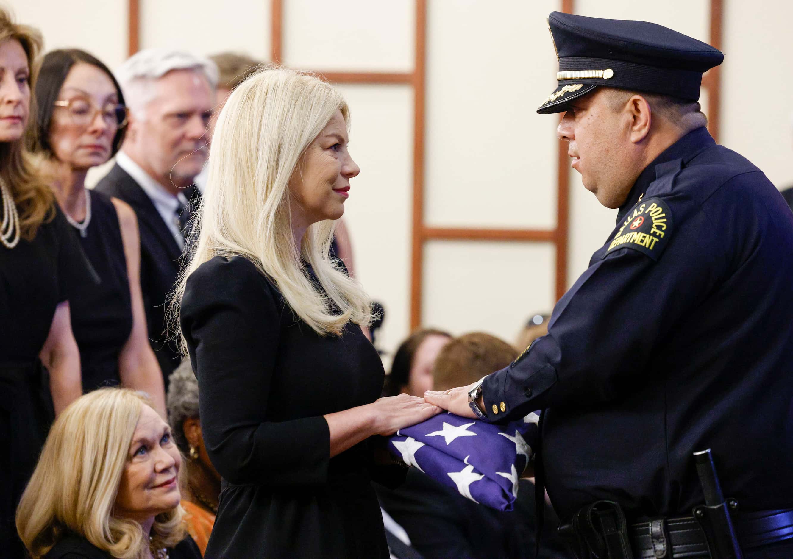 Dallas police Executive Assistant Chief Albert Martinez presents a flag to David Kunkle’s...