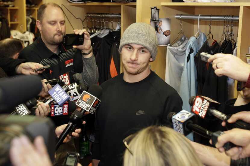 Cleveland Browns quarterback Johnny Manziel talks with the media at the NFL football team's...