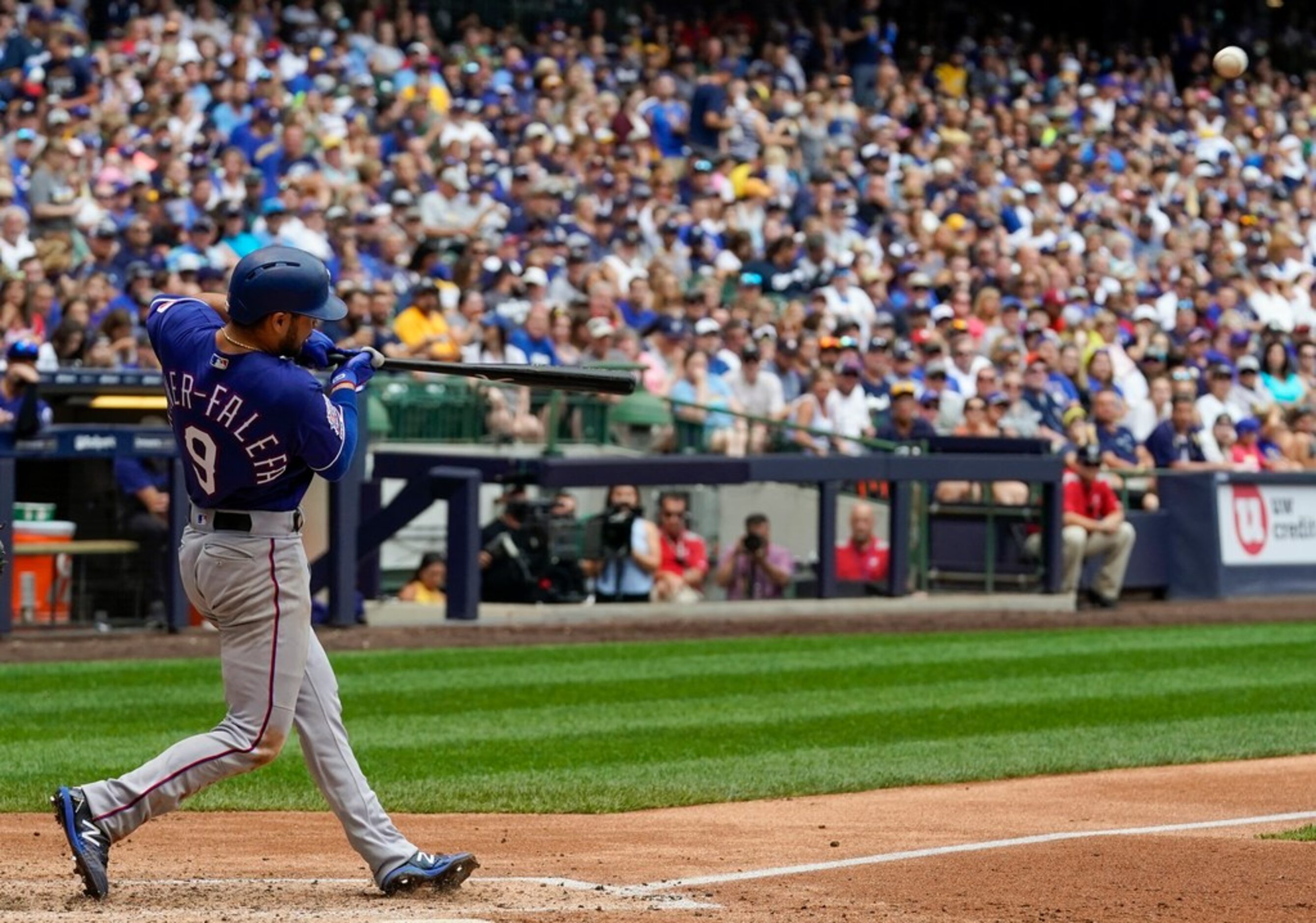 Texas Rangers' Isiah Kiner-Falefa hits a sacrifice fly during the seventh inning of a...