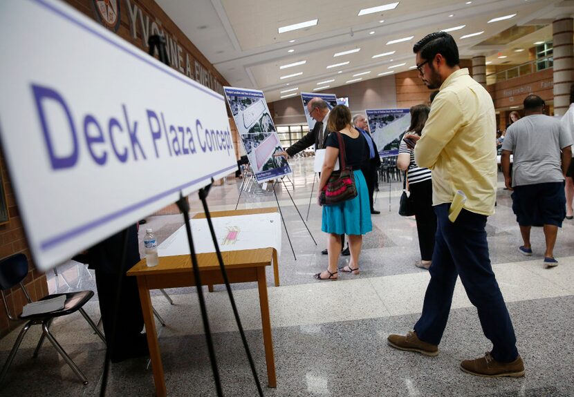 Jason Medina, an Oak Cliff resident, looked at plans on the proposed Oak Cliff deck park...